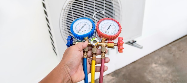 Technician checking the operation of the air conditioner.