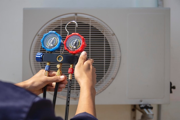 Technician checking the operation of the air conditioner