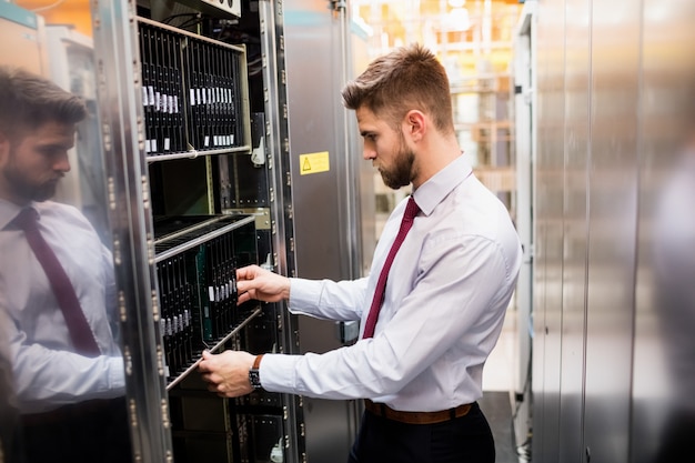 Technician examining server