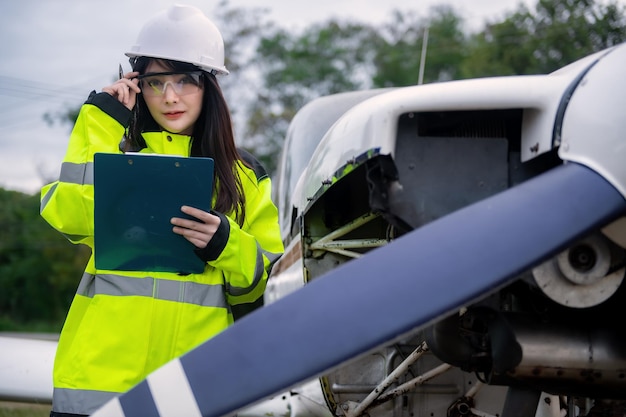 Technician fixing the engine of the airplaneFemale aerospace engineering checking aircraft enginesAsian mechanic maintenance inspects plane engine