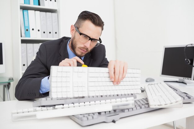 Technician fixing keyboard with screw driver