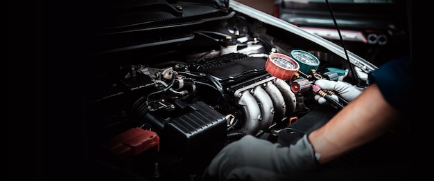 Photo technician hand and measuring manifold gauge checking car air conditioner