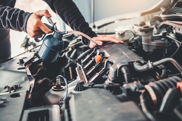 Technician hands of car mechanic working in auto repair