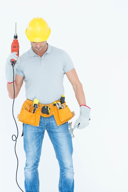 Photo technician holding drill machine over white background