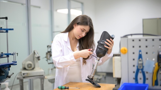 Technician holding prosthetic leg checking and controlling quality