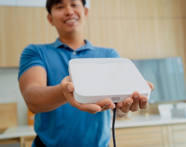 A technician installs a main unit security system in a modern apartment