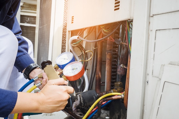 Technician is checking air conditioner