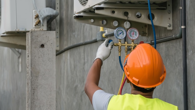 Technician is checking air conditioner 