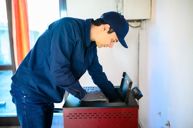 Technician maintaining a pellet stow heater