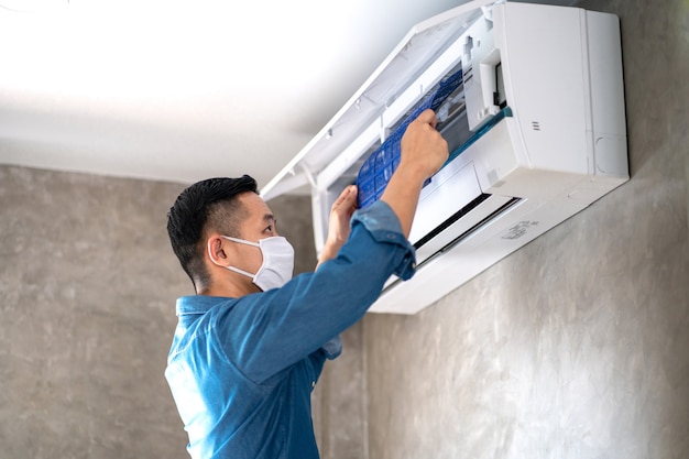 Technician man repairing ,cleaning and maintenance Air conditioner