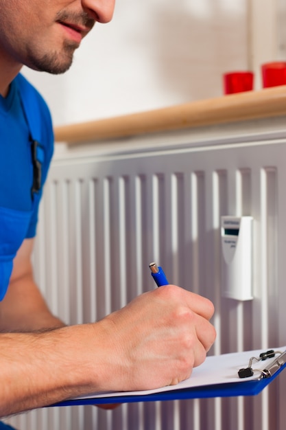 Technician reading the heat meter