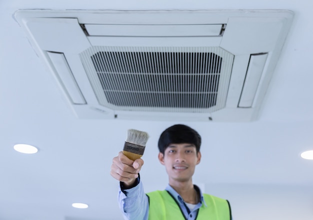 Technician repairing air conditioner on the wall 