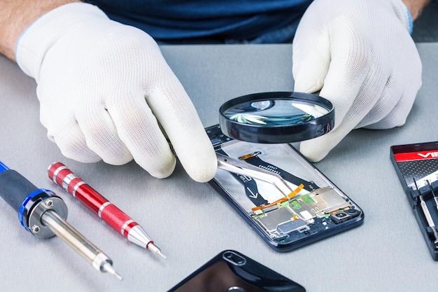 Technician Repairing Cellphone In Lab.