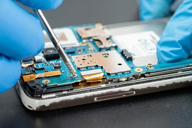 Technician repairing inside of hard disk by soldering iron Integrated Circuit the concept of data hardware technician and technology