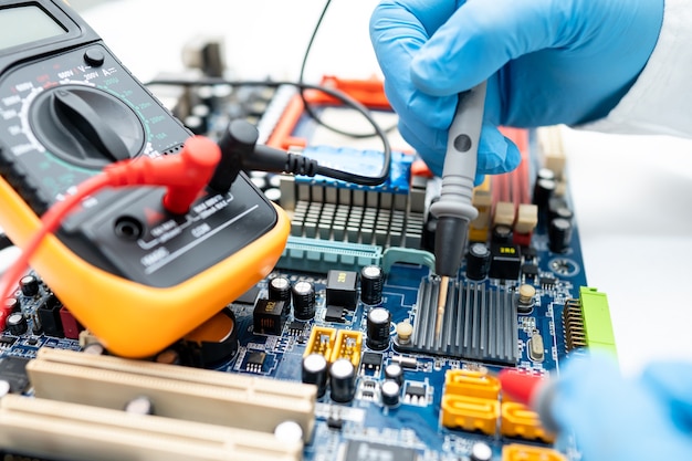 Technician repairing inside of hard disk by soldering iron.