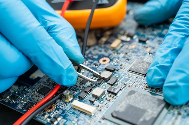 Technician repairing inside of hard disk by soldering iron