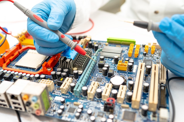 Technician repairing micro circuit main board computer.