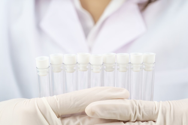 Technician scientist analyzing holding test tube in laboratory for testing it on COVID, COVID-19, coronavirus virus analysis