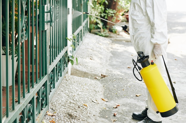 Technician spraying fence