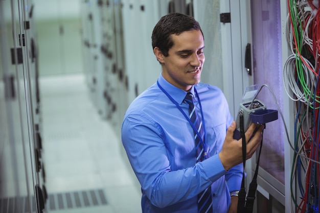 Photo technician using digital cable analyzer