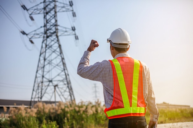 Photo technician with white helmet inspect high voltage power station