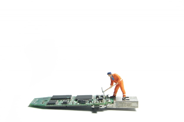 Technician worker figure standing on a old usb flash drive. IT support concept.