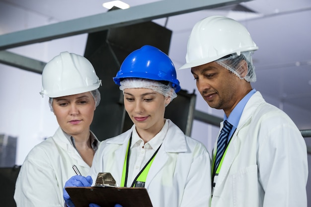 Technician writing on clipboard