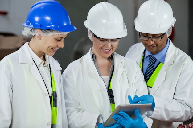 Technicians discussing over digital tablet