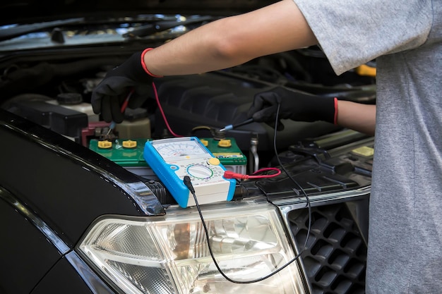 Technicians inspect the car's electrical system