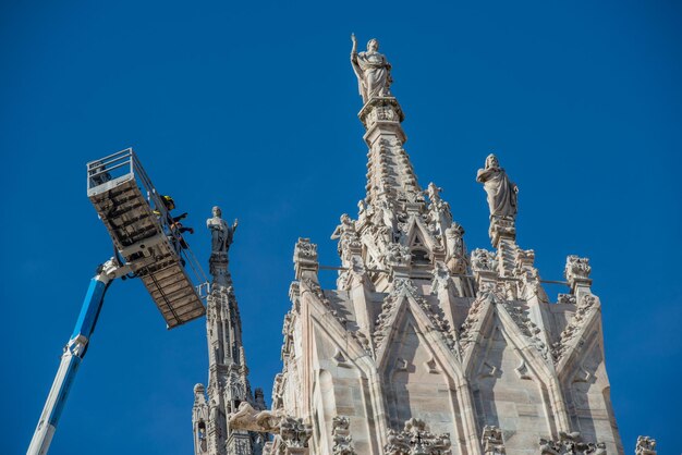 Technicians on lifting platform for scheduled maintenance plan
and study of the degradation phenomena of the milan cathedral