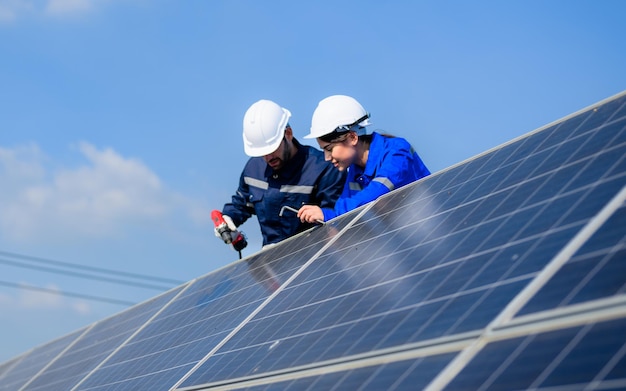 Technicians workers team installing solar panels at industrial solar cell farm