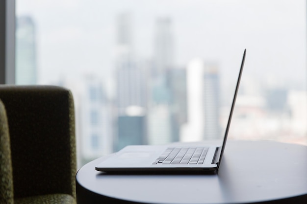 technology, business and modern life concept- close up of open laptop computer on table at office or hotel room