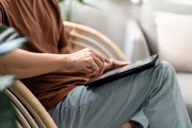 Technology Concept The male with his casual Tshirt and jeans sitting comfortably