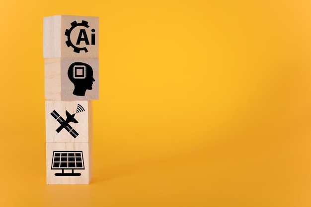 Technology concept with icons on wooden cubes yellow background