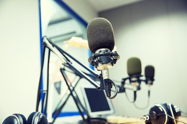 Photo technology, electronics and audio equipment concept - close up of microphone at recording studio or radio station