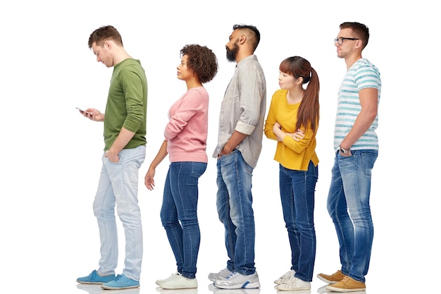 technology, ethnicity and people concept - international group of men and women in queue line with smartphone over white