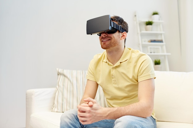 technology, gaming, entertainment and people concept - happy young man with virtual reality headset or 3d glasses playing video game