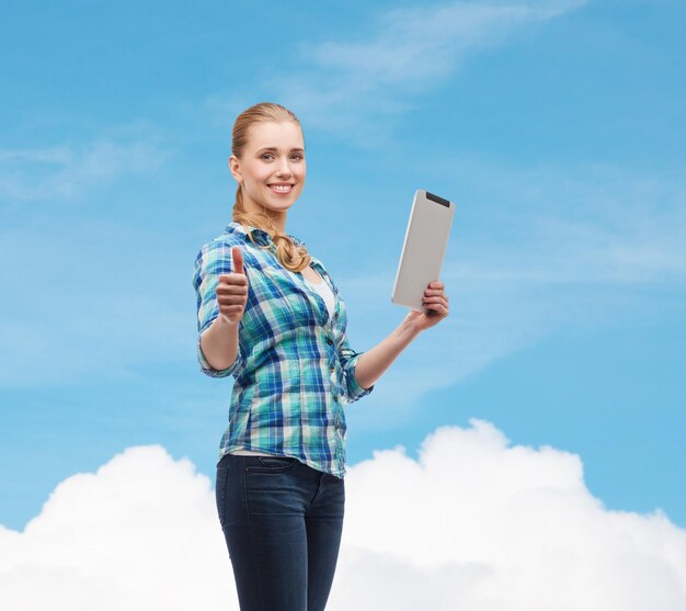 technology, internet and people concept - smiling girl with tablet pc computer showing thumbs up