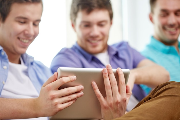 technology and people concept - close up of happy friends with tablet pc computers at home