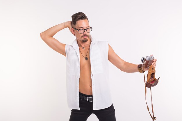 Technology, photography and people concept - Young handsome man in shirt taking a selfie over white