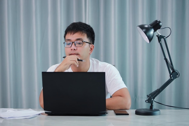 Technology remote job and lifestyle concept happy asian man man in glasses.