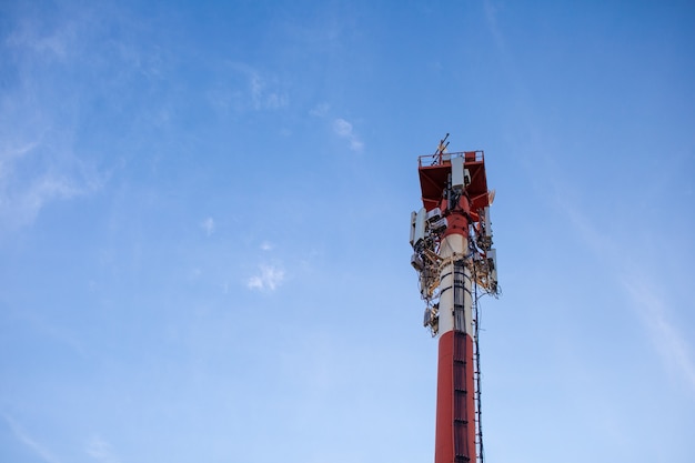 Technology on the top of the telecommunication GSM 5G,4G,3G tower.Cellular phone antennas on a building roof.Telecommunication mast television antennas.Receiving and transmitting stations