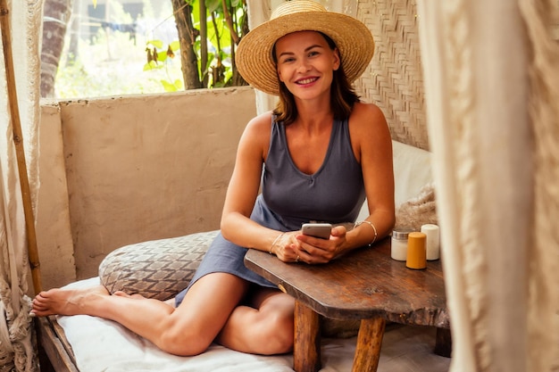 Technology and travel working outdoors freelance concept pretty
young woman in hat using laptop in cafe on tropical beachhooray
victory success and successful deal concept promotion at work