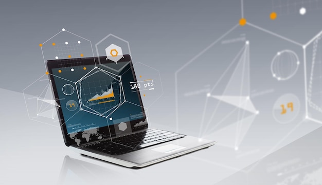 technology, virtual reality and statistics concept - laptop computer with chart and geometric shapes