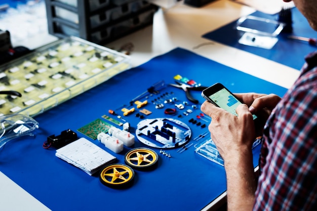 Tecnician hands texting message with robot tools on blue background