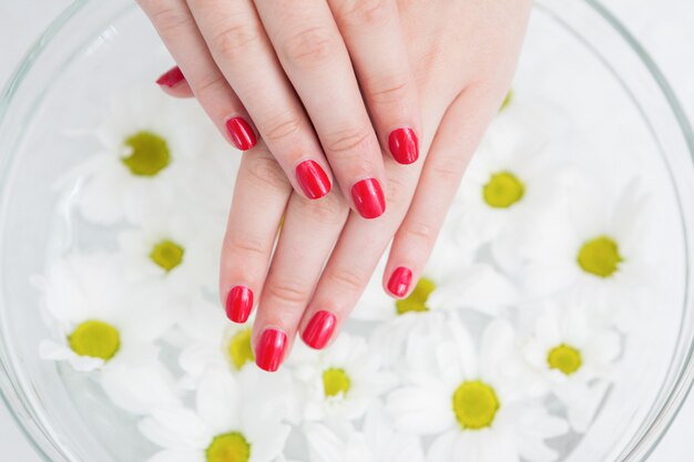 Ted painted finger nails and bowl of flowers