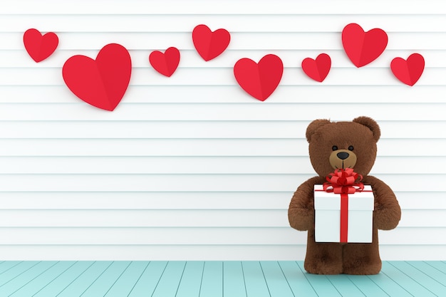 Teddy bear holding a gift box