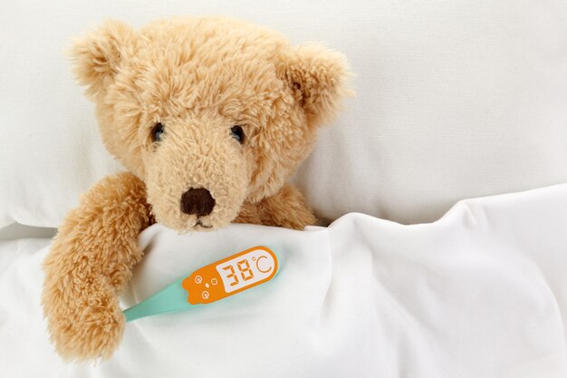 Teddy Bear is sick in bed