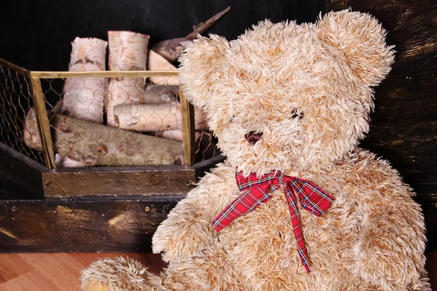 Teddy bear sitting near the fireplace