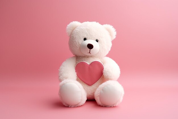 Teddy bear sitting on a pink background with a heart